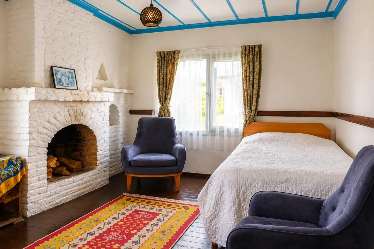 Morsalkım House's white fireplace, blue ceiling and seating area