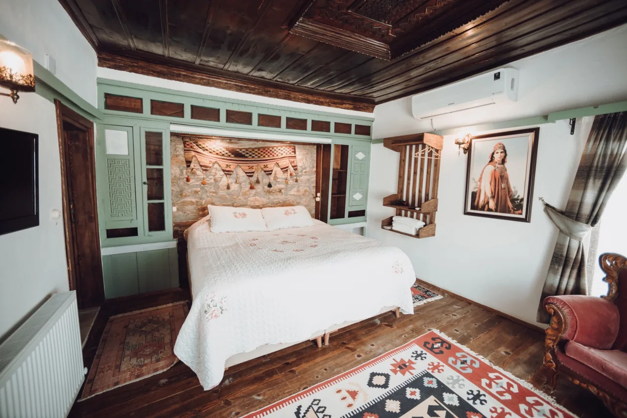 Sedir Room's wooden ceiling, stone wall and double bed