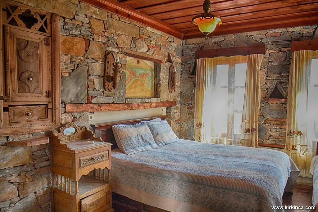 Zakkum Room's stone walls, wooden ceiling and bed